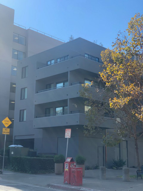 The apartment building from a sidewalk corner.